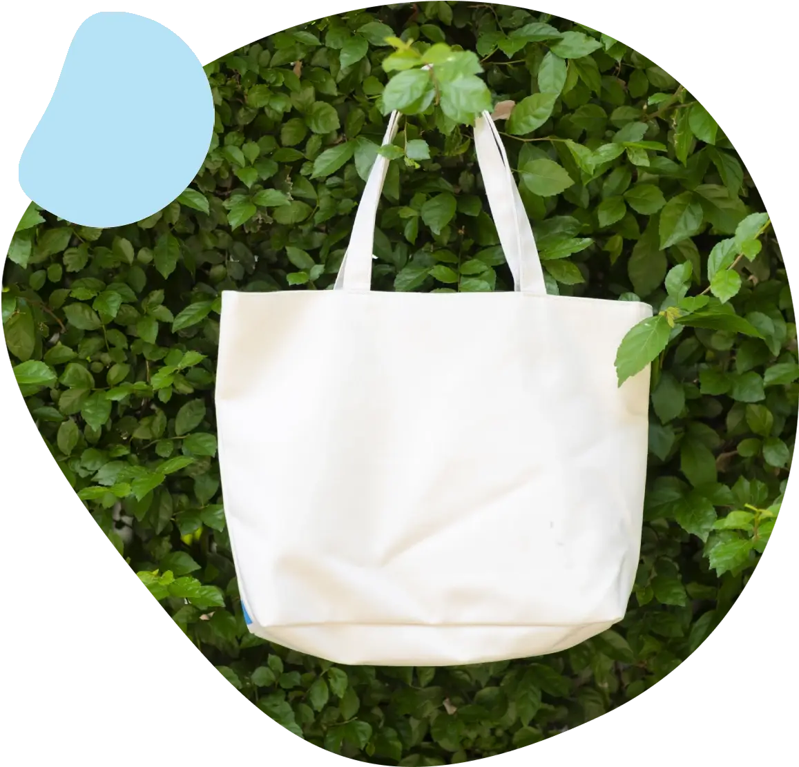 A white bag sitting in the middle of some bushes.